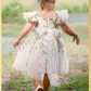 White floral girls and baby dress for flower girls, first birthdays and special occasions.  Sweetheart neckline, puffy sleeves, and knee length style in a fall floral tulle dress.