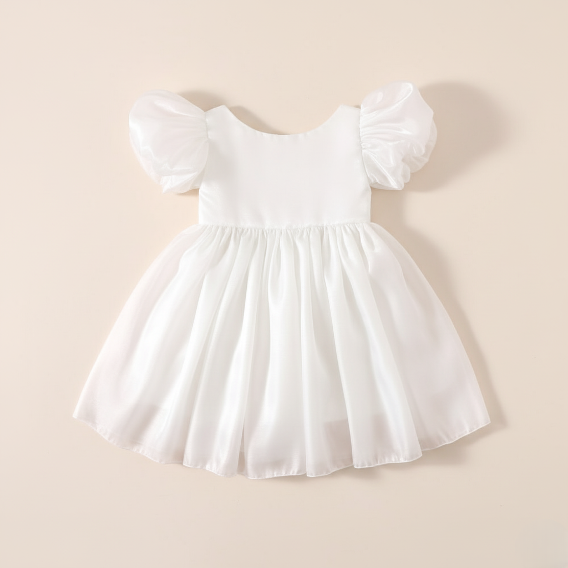 Girls white Christmas romper dress for holiday parties and family photos. In a short puffy sleeve style with shiny organza material for a knee length style