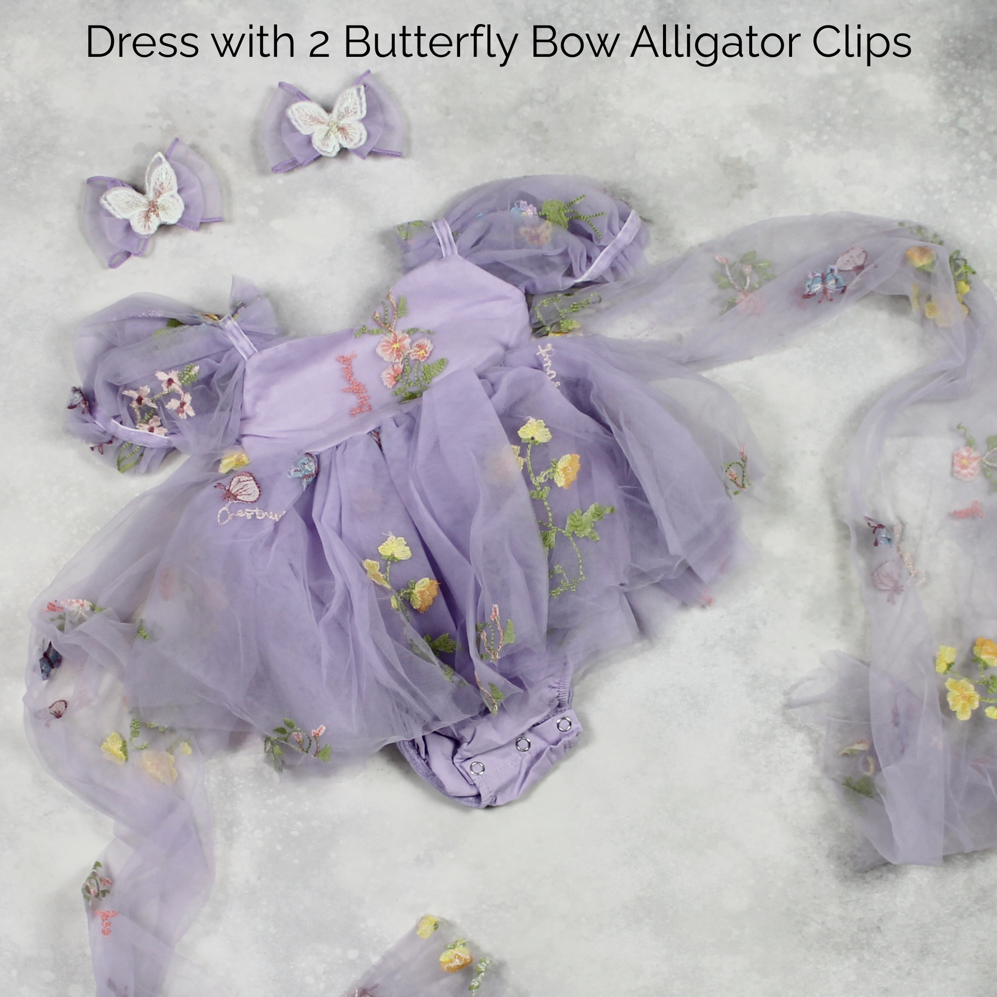 First birthday baby girl dress in lavender floral tulle with built in romper/bodysuit and puffy  short sleeves.