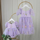 First birthday baby girl dress in lavender floral tulle with built in romper/bodysuit and puffy  short sleeves.