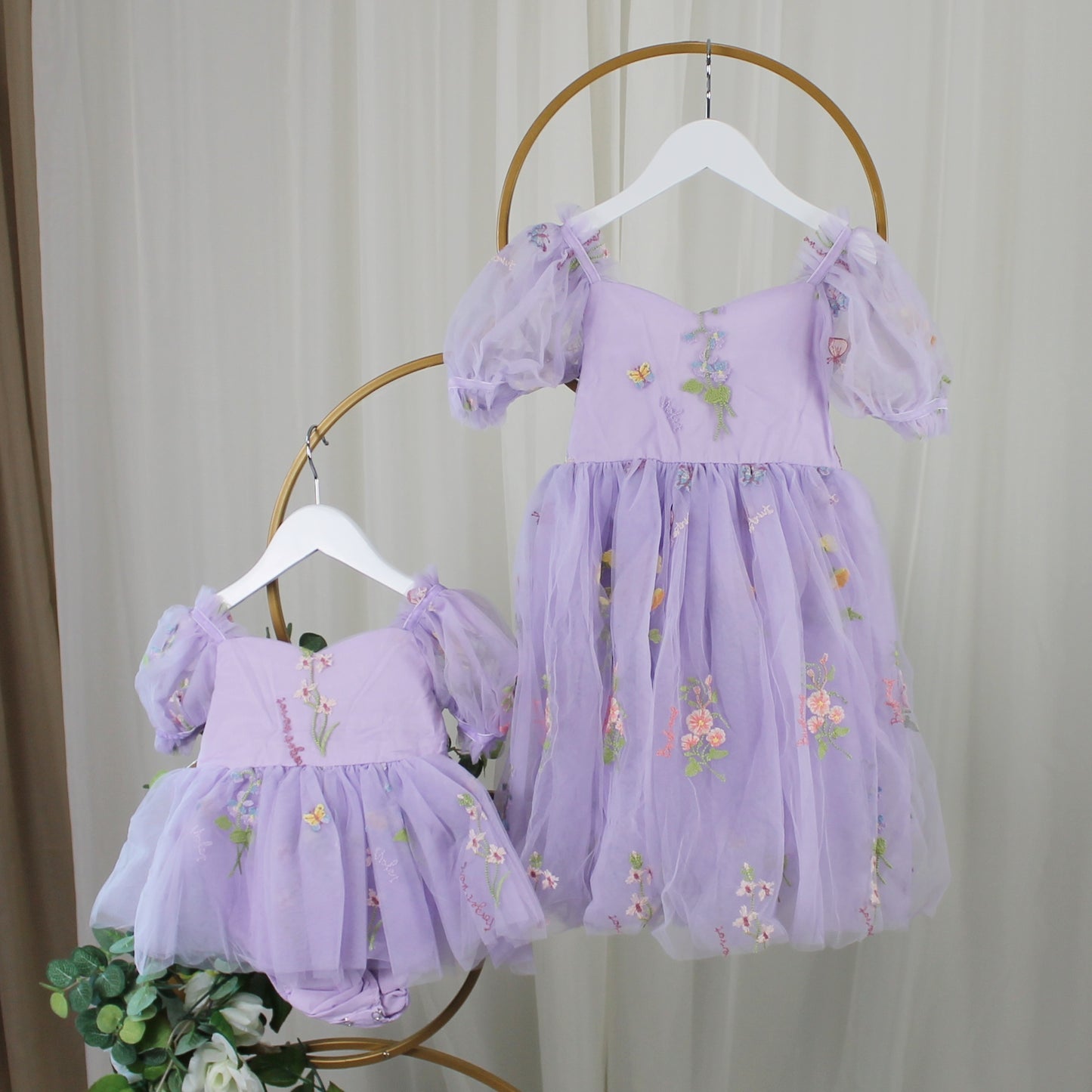 First birthday baby girl dress in lavender floral tulle with built in romper/bodysuit and puffy  short sleeves.