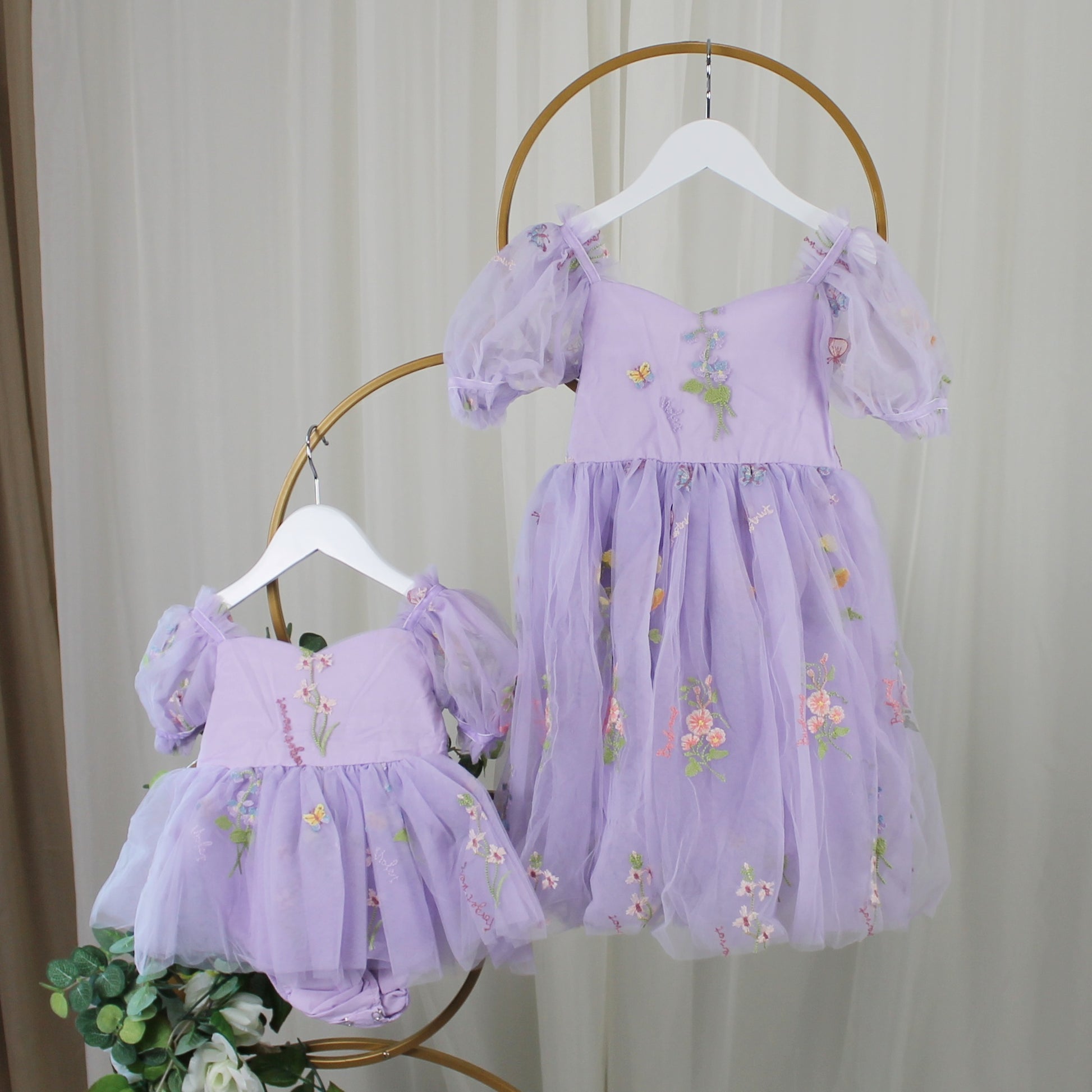 First birthday baby girl dress in lavender floral tulle with built in romper/bodysuit and puffy  short sleeves.
