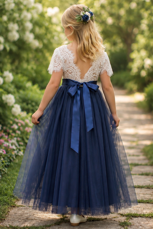 navy blue flower girl dress featuring short lace sleeves and a full length navy tulle length dress.