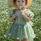 Sage floral flower girl dress for babies and toddlers for an upcoming wedding or birthday party. Puff sleeves and big tulle bow. 