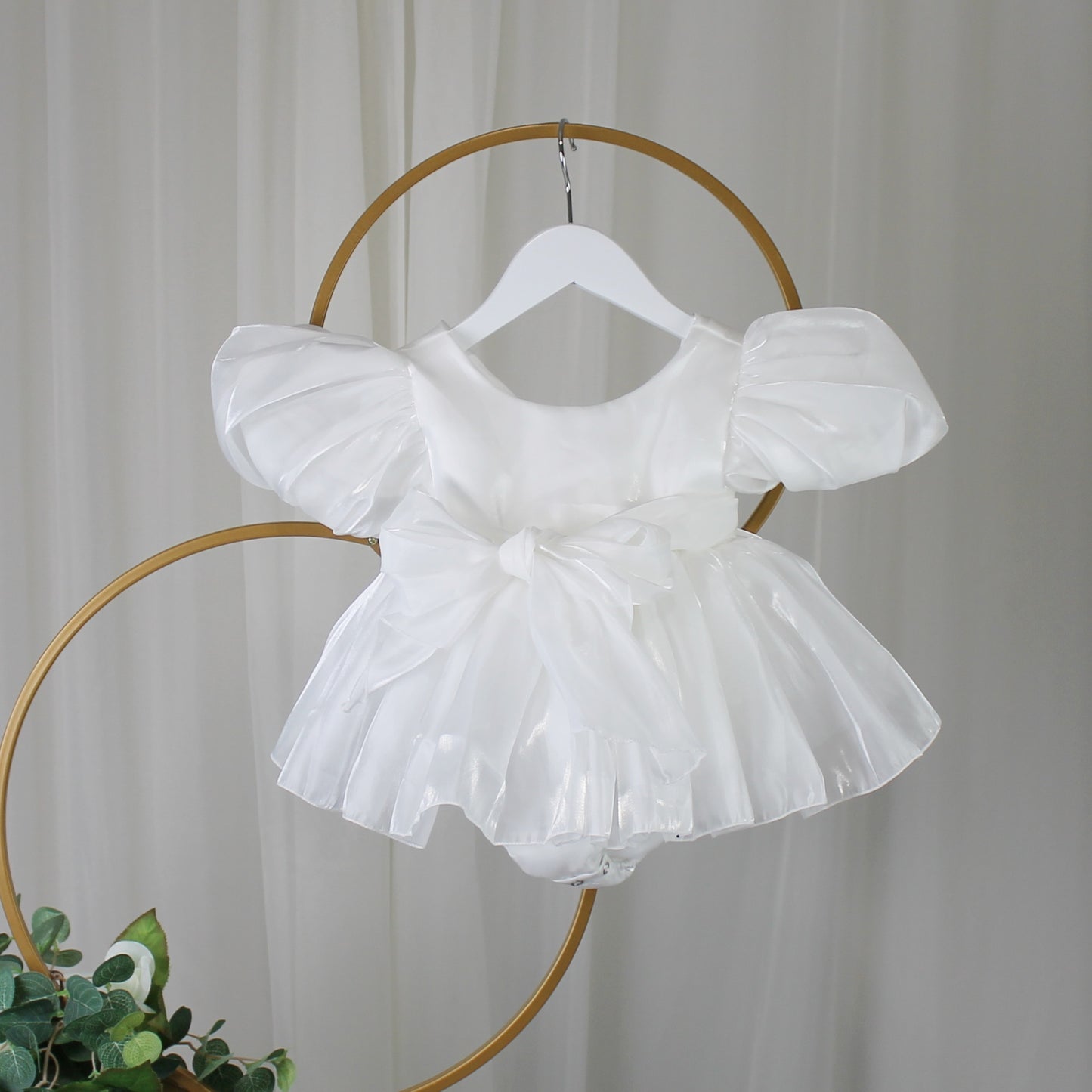Baby Girls white Christmas romper dress for holiday parties and family photos. In a short puffy sleeve style with shiny organza material for a short midi thigh style
