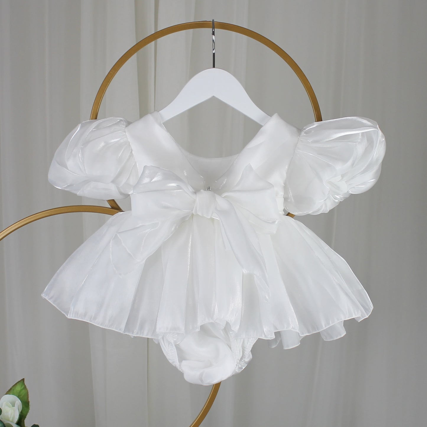 Baby Girls white Christmas romper dress for holiday parties and family photos. In a short puffy sleeve style with shiny organza material for a short midi thigh style