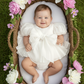 Baby Girls white Christmas romper dress for holiday parties and family photos. In a short puffy sleeve style with shiny organza material for a short midi thigh style
